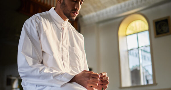 We are to pray in times of security. Shot of a young muslim male praying in a mosque